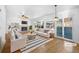 Bright living room featuring a fireplace, ceiling fan, and sliding door for outdoor access at 13058 Monaco Way, Thornton, CO 80602