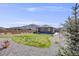 Expansive backyard with lush green grass, a patio area, and privacy fencing, perfect for outdoor activities at 13437 Waterthrush St, Parker, CO 80134