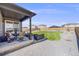 Serene backyard featuring a covered patio, manicured lawn, and gravel landscaping, offering a peaceful retreat at 13437 Waterthrush St, Parker, CO 80134