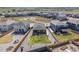 Aerial view of a fenced backyard featuring a green lawn, gravel area, and fire pit in a residential community at 13437 Waterthrush St, Parker, CO 80134