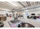 Partially finished basement area featuring exercise equipment and storage solutions at 13437 Waterthrush St, Parker, CO 80134