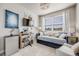 Versatile bedroom with a daybed, desk, and TV, perfect for a home office or guest room at 13437 Waterthrush St, Parker, CO 80134