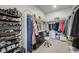 Well-organized walk-in closet with shelving for shoes and clothes, complemented by a vanity area with a stool at 13437 Waterthrush St, Parker, CO 80134