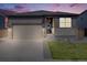 Charming single-Gathering home featuring a two-car garage, well-manicured lawn, and stylish gray exterior at 13437 Waterthrush St, Parker, CO 80134