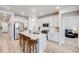 Modern kitchen featuring white cabinets, stainless steel appliances, and a large island with seating at 13437 Waterthrush St, Parker, CO 80134