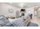 Comfortable living room with a fireplace, plush seating, and a view into other rooms at 13437 Waterthrush St, Parker, CO 80134