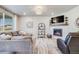 Cozy living room with a fireplace, plush seating, and a large window with natural light at 13437 Waterthrush St, Parker, CO 80134