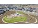 Aerial view of a community park with a playground, walking paths, and green spaces surrounded by residential homes at 13437 Waterthrush St, Parker, CO 80134