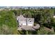 Sprawling property featuring a well-maintained home, three-car garage, and a circular driveway surrounded by mature trees at 5390 S Boston St, Greenwood Village, CO 80111
