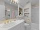 Bright bathroom with tiled floors, white vanity, shower and tub combo, and gold fixtures at 5390 S Boston St, Greenwood Village, CO 80111