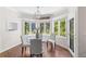 Bright breakfast nook features a modern chandelier, table with chairs, and a large bay window at 5390 S Boston St, Greenwood Village, CO 80111