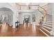Grand foyer with wood floors, staircase, chandelier, and arched doorways to adjacent living spaces at 5390 S Boston St, Greenwood Village, CO 80111