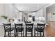 Spacious kitchen with counter seating, modern appliances, and views to the connected breakfast nook at 5390 S Boston St, Greenwood Village, CO 80111