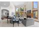 Spacious living room with high ceilings, arched windows, a fireplace, and comfortable seating arrangements at 5390 S Boston St, Greenwood Village, CO 80111