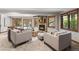 Cozy living room with a brick fireplace, plush seating, and a view of the pool at 5390 S Boston St, Greenwood Village, CO 80111