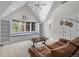 Cozy living room with a large window seat, leather couch, and hardwood floors at 5390 S Boston St, Greenwood Village, CO 80111