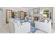 Inviting living room with a marble fireplace, comfortable white sofas, and natural light from large windows at 5390 S Boston St, Greenwood Village, CO 80111