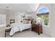 Bright main bedroom featuring a fireplace, light carpet, and large window allowing for ample natural light at 5390 S Boston St, Greenwood Village, CO 80111