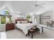 Spacious main bedroom featuring natural light, vaulted ceilings, and seating area at 5390 S Boston St, Greenwood Village, CO 80111