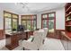 Office with a large desk, natural light, wooden paneling, and two upholstered chairs at 5390 S Boston St, Greenwood Village, CO 80111