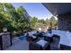 Inviting outdoor deck featuring comfortable seating, a dining area, and a view of the pool and yard at 5390 S Boston St, Greenwood Village, CO 80111