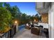 Inviting outdoor deck featuring comfortable seating, a dining area, and a view of the pool and yard at 5390 S Boston St, Greenwood Village, CO 80111