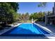 Inviting in-ground pool surrounded by lounge chairs and lush landscaping, perfect for relaxation and recreation at 5390 S Boston St, Greenwood Village, CO 80111
