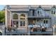 Elegant rear exterior with a spacious deck, multiple seating areas, and large windows overlooking the backyard at 5390 S Boston St, Greenwood Village, CO 80111