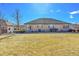 Expansive backyard featuring manicured lawn and a view of the property's exterior at 16773 W 61St Ln, Arvada, CO 80403