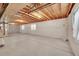 Unfinished basement with concrete flooring, exposed ceiling and natural light from windows at 16773 W 61St Ln, Arvada, CO 80403