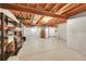 Large unfinished basement space with an exposed ceiling and storage shelves at 16773 W 61St Ln, Arvada, CO 80403