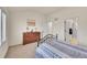 Bedroom with a neutral carpet, large window, and wood dresser at 16773 W 61St Ln, Arvada, CO 80403