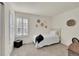 Cozy bedroom with natural light, shutters, and minimalist decor, perfect for restful sleep at 16773 W 61St Ln, Arvada, CO 80403