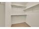 Walk-in closet with multiple shelves for storage, with carpeted floor at 16773 W 61St Ln, Arvada, CO 80403