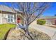 Inviting single-story home with a red front door and a well-manicured lawn, perfect for curb appeal at 16773 W 61St Ln, Arvada, CO 80403