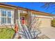 Charming home featuring a red front door, brick accents, and attached garage, creating a welcoming curb appeal at 16773 W 61St Ln, Arvada, CO 80403