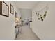 Well-lit hallway with decorative wall hangings leading to a cozy living space at 16773 W 61St Ln, Arvada, CO 80403