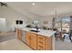 Bright, open kitchen with a large island, modern appliances, and dining area perfect for entertaining at 16773 W 61St Ln, Arvada, CO 80403