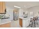 Kitchen with stainless steel refrigerator, white countertops, and breakfast bar seating at 16773 W 61St Ln, Arvada, CO 80403