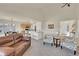 Open-concept living room flows into a kitchen with a breakfast bar and cozy seating area at 16773 W 61St Ln, Arvada, CO 80403