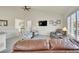 Bright living room with vaulted ceilings, a ceiling fan, and comfortable seating at 16773 W 61St Ln, Arvada, CO 80403