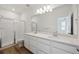 This bathroom has double sinks, modern vanity, full mirror and glass enclosed shower at 1366 Penner Dr, Erie, CO 80026