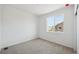 Minimalist bedroom with neutral carpet and a large window offering natural light at 1366 Penner Dr, Erie, CO 80026