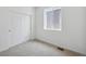 A comfortable bedroom with neutral carpet, closet and large window providing light at 1366 Penner Dr, Erie, CO 80026