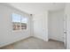 This bedroom features neutral carpet, large closet and a large window for plenty of natural light at 1366 Penner Dr, Erie, CO 80026