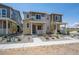 Charming two-story home with stone accents, inviting front porch, and well-manicured landscaping at 1366 Penner Dr, Erie, CO 80026
