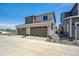Exterior shot of a two-car garage and concrete driveway in front of gray home at 1366 Penner Dr, Erie, CO 80026