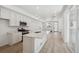 Spacious kitchen featuring a center island with seating, stainless steel appliances, and modern white cabinetry at 1366 Penner Dr, Erie, CO 80026