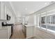 Modern kitchen with stainless appliances, center island, and sliding glass doors leading to outdoor space at 1366 Penner Dr, Erie, CO 80026