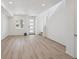 Open-concept living room with hardwood floors, large windows, and staircase leading to the upper level at 1366 Penner Dr, Erie, CO 80026